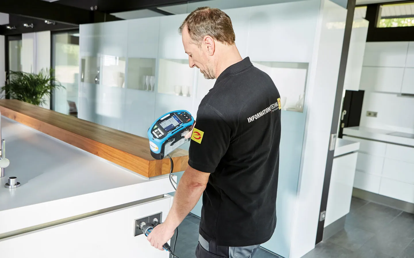 E-CHECK - Mitarbeiter prüft die Steckdosen in der Küche &middot; Elektro-Stock